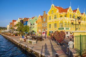 using a watermaker watermakers in Curaçao. Beautiful colorful buildings by the water in Curaçao. A clear blue sky.